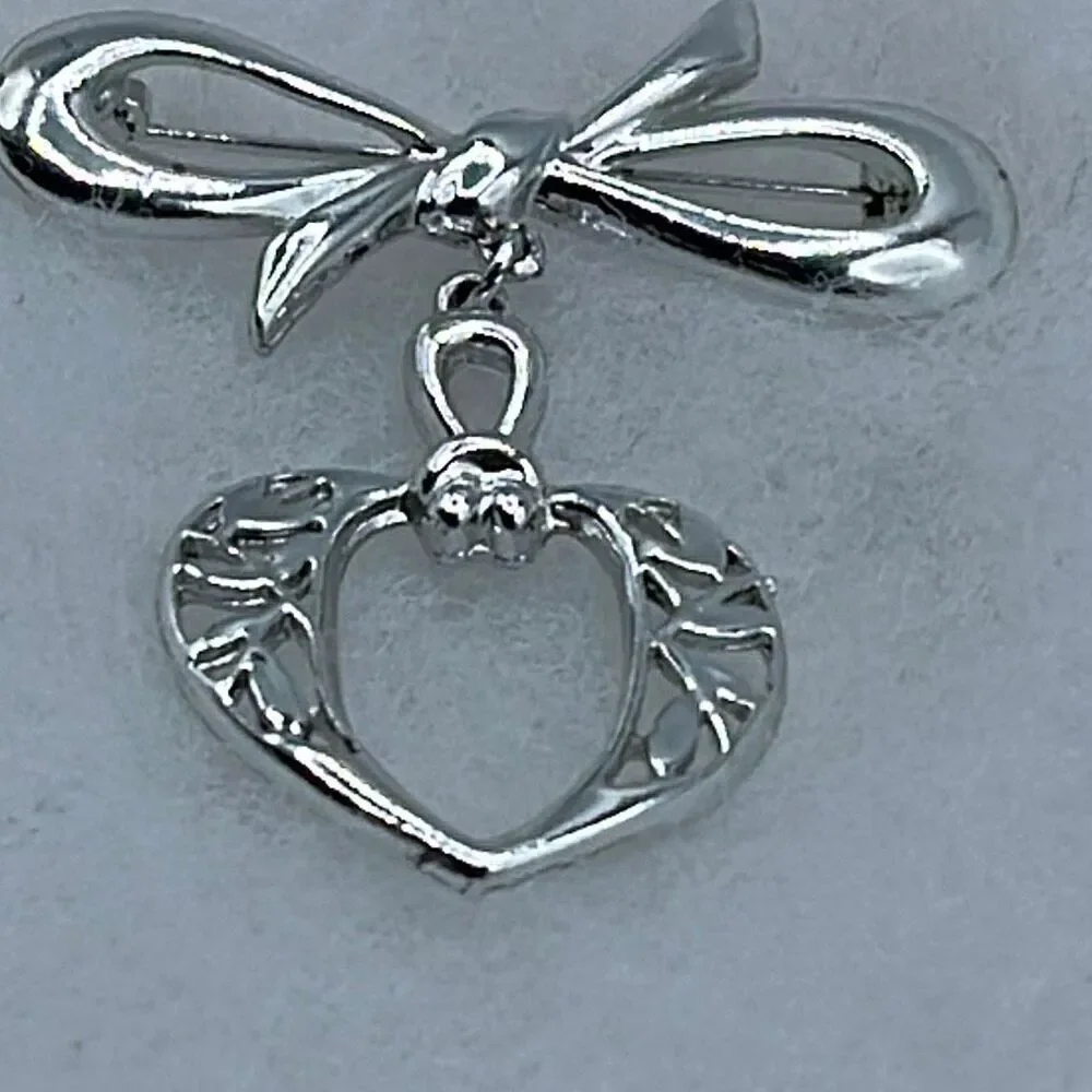 Vintage stylized bow and dangle heart brooch